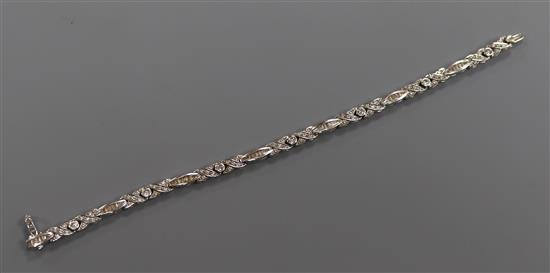A modern 18ct white gold and diamond set line bracelet set with round and baguette cut stones, 17.5cm.